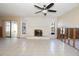 Living room view showcasing a stone fireplace and tiled flooring undergoing renovations at 7623 Mako Dr, Hudson, FL 34667