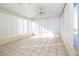 Bright sunroom featuring tiled floors, white walls, and a ceiling fan for added comfort at 7623 Mako Dr, Hudson, FL 34667