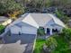 Beautiful one-story home with a three-car garage and lush landscaping at 817 Wilkie St, Dunedin, FL 34698