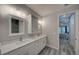 Bathroom features double vanity with white countertop, and a view to the Primary bedroom at 817 Wilkie St, Dunedin, FL 34698