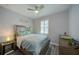 Bedroom features neutral color palette, queen-sized bed and accent furniture and shutters at 817 Wilkie St, Dunedin, FL 34698