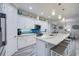 Well-equipped kitchen featuring white cabinetry, stainless steel appliances, and a stylish backsplash at 817 Wilkie St, Dunedin, FL 34698