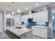 Bright kitchen with a center island, stainless steel appliances, and stylish white cabinetry at 817 Wilkie St, Dunedin, FL 34698