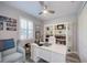 Office with desk, chair, ceiling fan, shutters, and wall to wall shelving at 817 Wilkie St, Dunedin, FL 34698