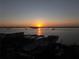 Scenic sunset view over the ocean, buildings, and boats at 817 Wilkie St, Dunedin, FL 34698