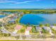 Aerial view of a beautiful home with a screened-in pool and a serene lake view at 833 Seminole Sky Dr, Ruskin, FL 33570