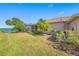 Beautiful backyard with a screened lanai, lush landscaping and lake views at 833 Seminole Sky Dr, Ruskin, FL 33570