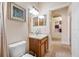 Well-lit bathroom featuring a single vanity, a decorative mirror and a neutral color palette at 833 Seminole Sky Dr, Ruskin, FL 33570