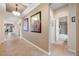 Hallway with tile floors, artwork, and views of the bathroom and dining room at 833 Seminole Sky Dr, Ruskin, FL 33570