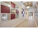 Hallway with tile floors, mirrors, and views of the dining room and bathroom at 833 Seminole Sky Dr, Ruskin, FL 33570