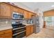 A well-equipped kitchen features stainless steel appliances and custom wood cabinetry at 833 Seminole Sky Dr, Ruskin, FL 33570