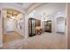 Spacious living area featuring tiled floors, archways, a display cabinet, and natural light from the entry door at 833 Seminole Sky Dr, Ruskin, FL 33570