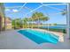 An inviting pool with a screened enclosure and lake views at 833 Seminole Sky Dr, Ruskin, FL 33570