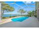 Relaxing in-ground pool with screened enclosure and lake views at 833 Seminole Sky Dr, Ruskin, FL 33570