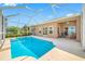 Outdoor pool with screen enclosure adjacent to backyard and water at 833 Seminole Sky Dr, Ruskin, FL 33570