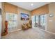 Cozy sitting area with tiled floors, natural lighting, and comfortable seating near a sliding glass door at 833 Seminole Sky Dr, Ruskin, FL 33570