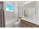 Bright bathroom features a shower-tub combo, stylish vanity, and natural light at 9273 Highland Hills Dr, Hudson, FL 34667