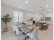 Dining room with modern table and chairs connected to a kitchen with an island at 9273 Highland Hills Dr, Hudson, FL 34667