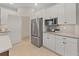 Kitchen featuring white cabinets, stainless steel appliances and light countertops at 9273 Highland Hills Dr, Hudson, FL 34667