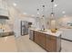 Bright kitchen featuring stainless steel appliances, a kitchen island and modern pendant lighting at 9273 Highland Hills Dr, Hudson, FL 34667