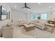 Spacious living room with a ceiling fan and modern furniture at 9273 Highland Hills Dr, Hudson, FL 34667