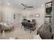 Well-lit home office featuring a ceiling fan, a desk, and a bookshelf creating a cozy and functional workspace at 9273 Highland Hills Dr, Hudson, FL 34667