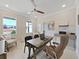 Brightly lit home office featuring a ceiling fan, a desk, and a comfortable chair near the window at 9273 Highland Hills Dr, Hudson, FL 34667