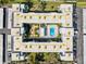 Drone's-eye view of the community highlighting a central courtyard, pool, and meticulously arranged parking at 1706 Belleair Forest Dr # 348, Belleair, FL 33756