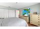 Bedroom with a large closet, dresser, and beach-themed television as decor at 1706 Belleair Forest Dr # 348, Belleair, FL 33756