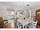 Cozy dining area featuring a table with seating for four and a decorative chandelier at 1706 Belleair Forest Dr # 348, Belleair, FL 33756