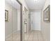 Inviting hallway with tile flooring and closet with mirror doors, leading to a cozy kitchen at 1706 Belleair Forest Dr # 348, Belleair, FL 33756