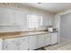 Bright kitchen featuring white appliances and plenty of storage space for all your cooking needs at 1706 Belleair Forest Dr # 348, Belleair, FL 33756