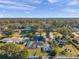 An aerial view shows a home with a pool, surrounded by lush trees, with other houses in the neighborhood visible at 1016 Mandalay Dr, Brandon, FL 33511