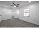 Bright living room featuring modern gray floors, a ceiling fan and natural light at 1016 Mandalay Dr, Brandon, FL 33511