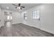 Bright living room featuring modern gray floors, a ceiling fan and natural light at 1016 Mandalay Dr, Brandon, FL 33511