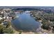 Sprawling community with a serene lake surrounded by homes and lush greenery at 10525 Mira Vista Dr, Port Richey, FL 34668