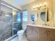 Modern bathroom showcasing double sinks, decorative mirrors, and a glass-enclosed shower at 10525 Mira Vista Dr, Port Richey, FL 34668