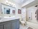 The half bathroom has a grey vanity with white sink, a toilet and a tub/shower combo at 10525 Mira Vista Dr, Port Richey, FL 34668