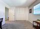 The bedroom has gray walls and carpet and a folding door closet at 10525 Mira Vista Dr, Port Richey, FL 34668
