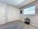 The bedroom features a carpet, a window with blinds and a closet with folding doors at 10525 Mira Vista Dr, Port Richey, FL 34668