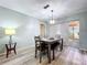 Contemporary dining room with stylish wood table, chairs, and a modern light fixture at 10525 Mira Vista Dr, Port Richey, FL 34668