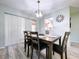 A charming dining room features a modern light fixture, and a glimpse into the adjacent kitchen at 10525 Mira Vista Dr, Port Richey, FL 34668