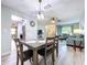 An open-concept living space features a dining area adjacent to the living room, with a view into the kitchen at 10525 Mira Vista Dr, Port Richey, FL 34668