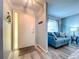 Bright entryway featuring wood-look flooring, a modern front door, and a glimpse into the cozy living area at 10525 Mira Vista Dr, Port Richey, FL 34668