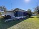 Home exterior featuring a sunroom and well-maintained landscaping at 10525 Mira Vista Dr, Port Richey, FL 34668