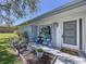 Charming front porch featuring comfortable seating, beautiful plants, and a welcoming entryway to the home at 10525 Mira Vista Dr, Port Richey, FL 34668