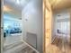 This hallway leads from the living room to the bathroom and features luxury vinyl flooring at 10525 Mira Vista Dr, Port Richey, FL 34668