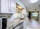 Beautiful kitchen features granite countertops, stainless appliances, and a seamless connection to the living space at 10525 Mira Vista Dr, Port Richey, FL 34668