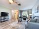 Open-concept living room with wood floors, modern furnishings, and a television entertainment area at 10525 Mira Vista Dr, Port Richey, FL 34668
