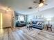 Bright and airy living room with wood floors, comfortable seating, and stylish decor at 10525 Mira Vista Dr, Port Richey, FL 34668